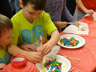 Boys learning to use chopsticks