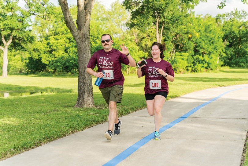 Man and woman running in 5K race