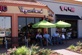 People sitting at outdoor table enjoying yogurt from Yogurtland at the Shops at Old Denton.