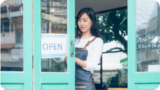 small business owner flipping open sign