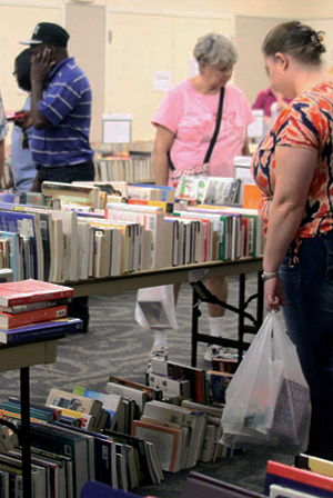 customers browsing book sale at Hebron and Josey Library