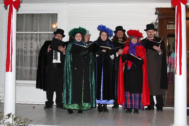 Victorian carolers singing on the front porch.