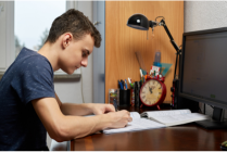 guy doing homework at desk