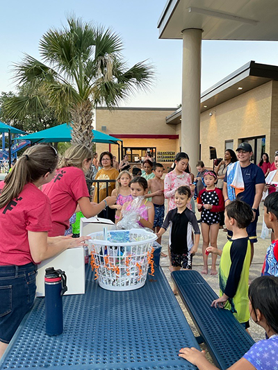 staff table at End of Summer Reading Pool Party