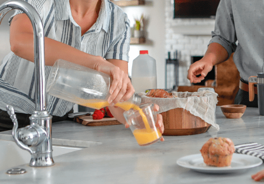 family-pouring-juice-plastic-bottle-min