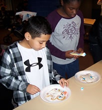 Decorating gingerbread during 12 Days of Winter Break